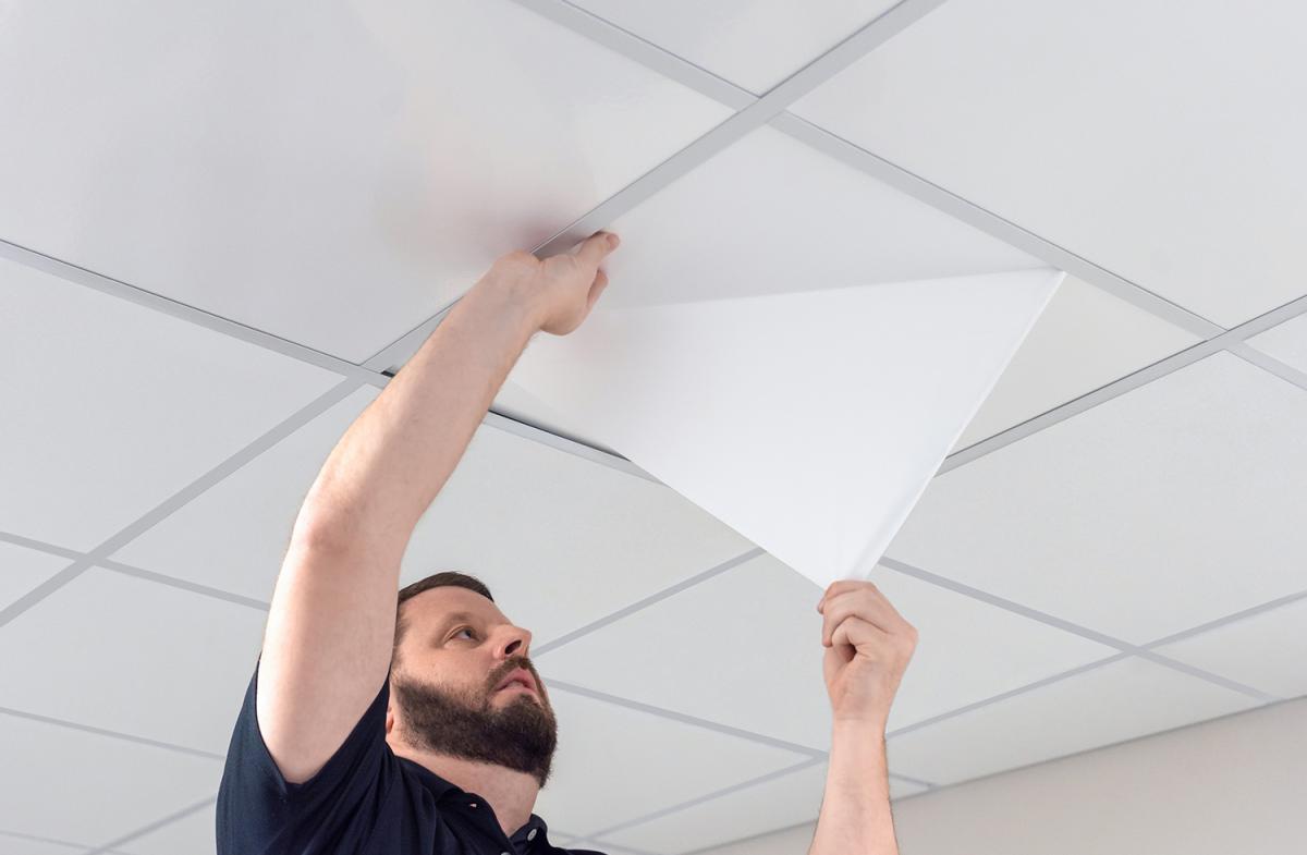 Man Peeling the SmartPeel Nova Ceiling Tile